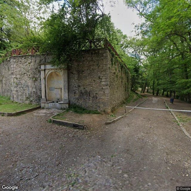 The fountain wall at the Bentler gate: an arched drinking fountain still set into old stone.