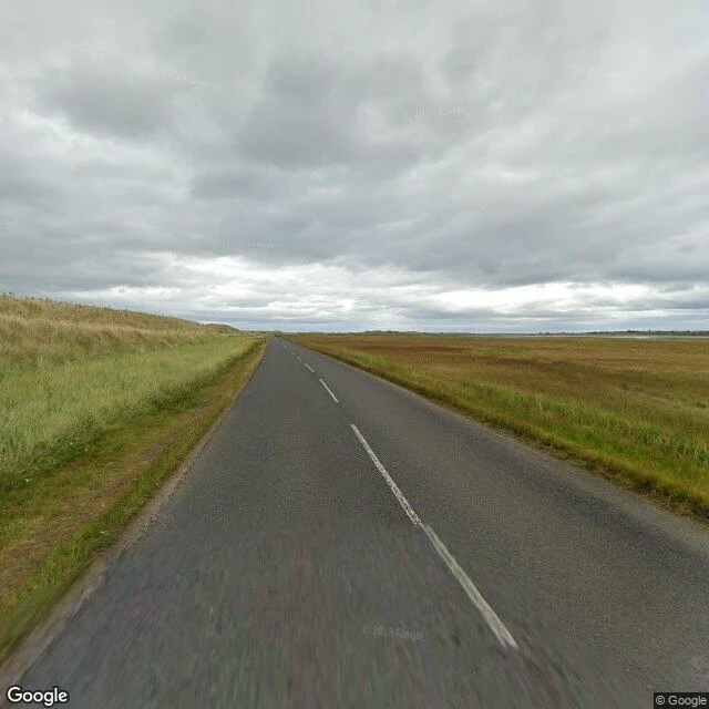 the way out — the dry causeway road running toward Lindisfarne, 2024-08