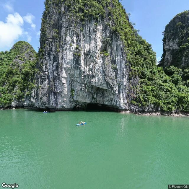 a sea cave arch cut at the waterline of a limestone cliff
