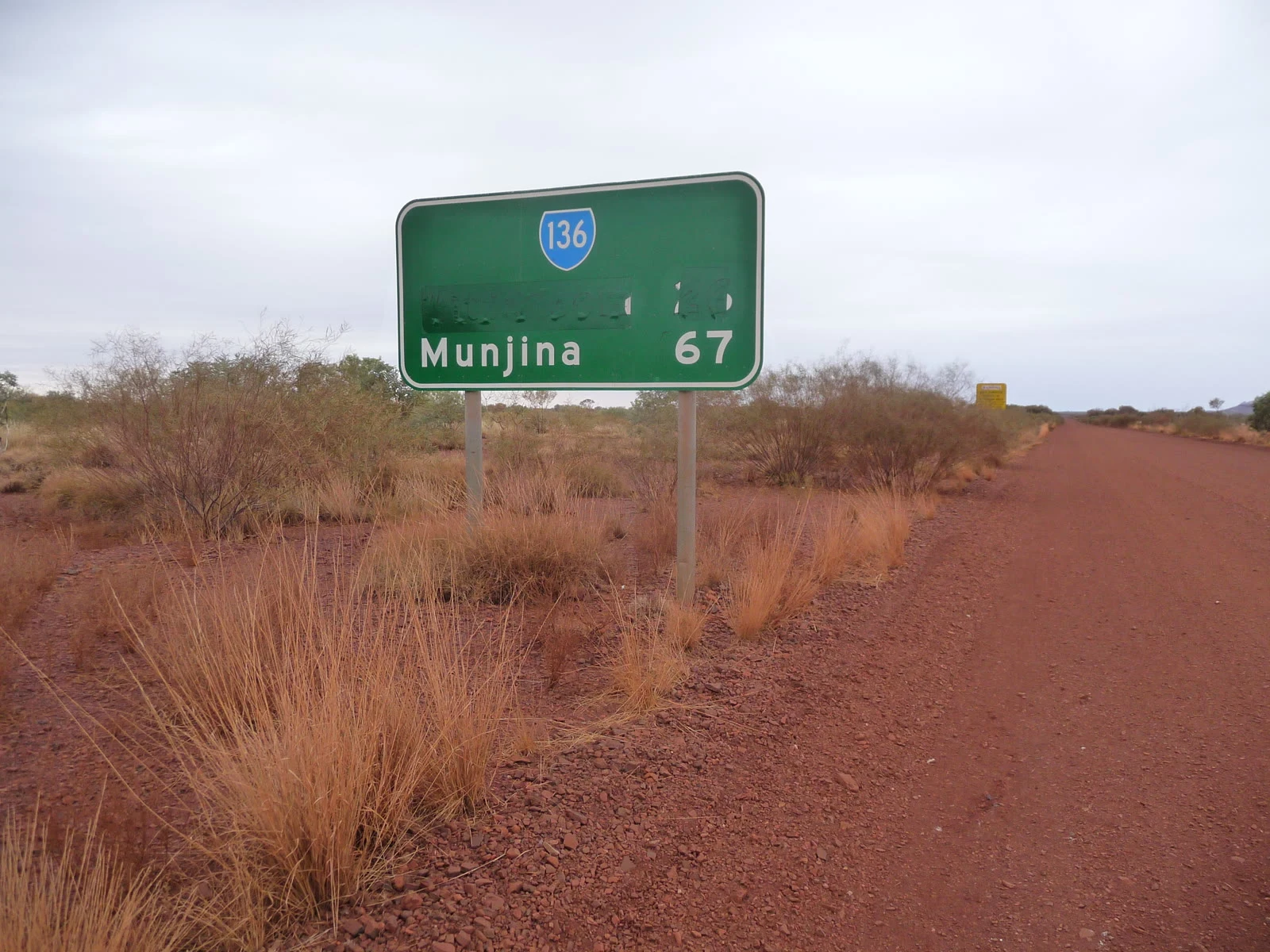 The road sign at the turnoff, the name painted over
